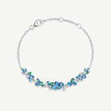 „Wisteria Whisper“ Flower Bar Armband aus blauem Topas und Silber