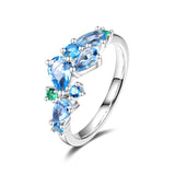 “Wisteria Whisper” Flower Bar Blue Topaz Silver Ring
