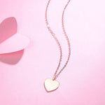 Minimalist style heart coin pendant necklace in 14k rose gold
