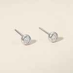 Domed round natural diamond studs in white gold